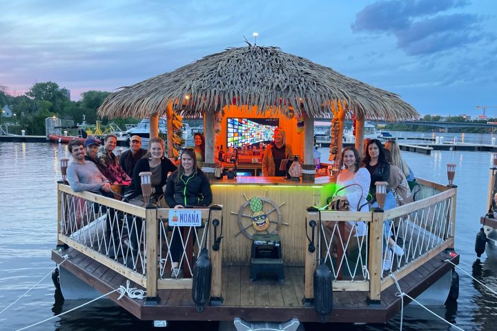 a group of people sitting at a dock